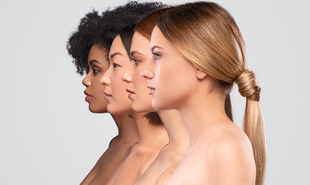 four beautiful women of different ethnicities standing in a row to show their facial contours and cheeks for Juvederm Voluma XC